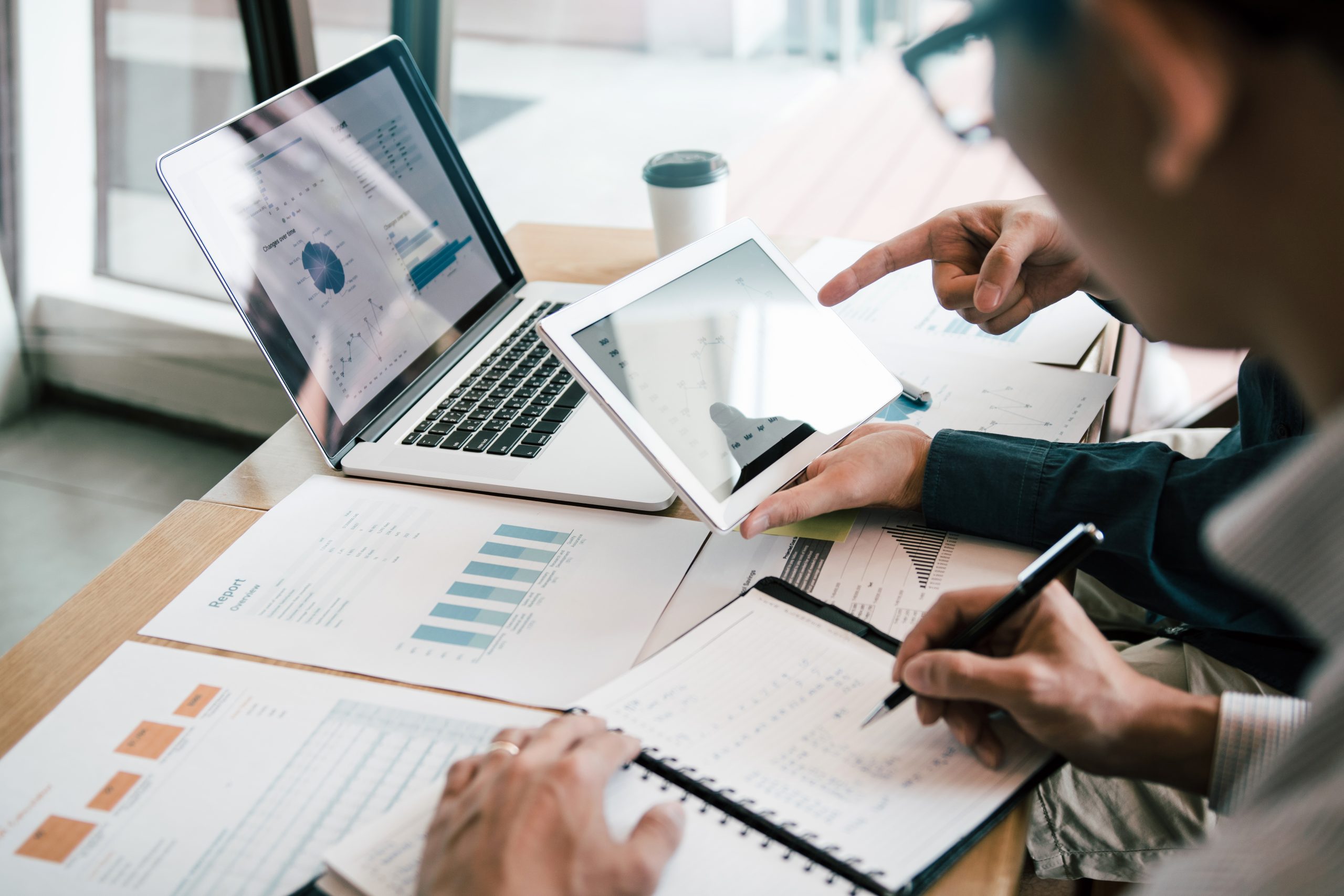 ICON Property Management colleagues using a tablet to analyze a financial budget report for a condominium corporation in Toronto, Ontario.