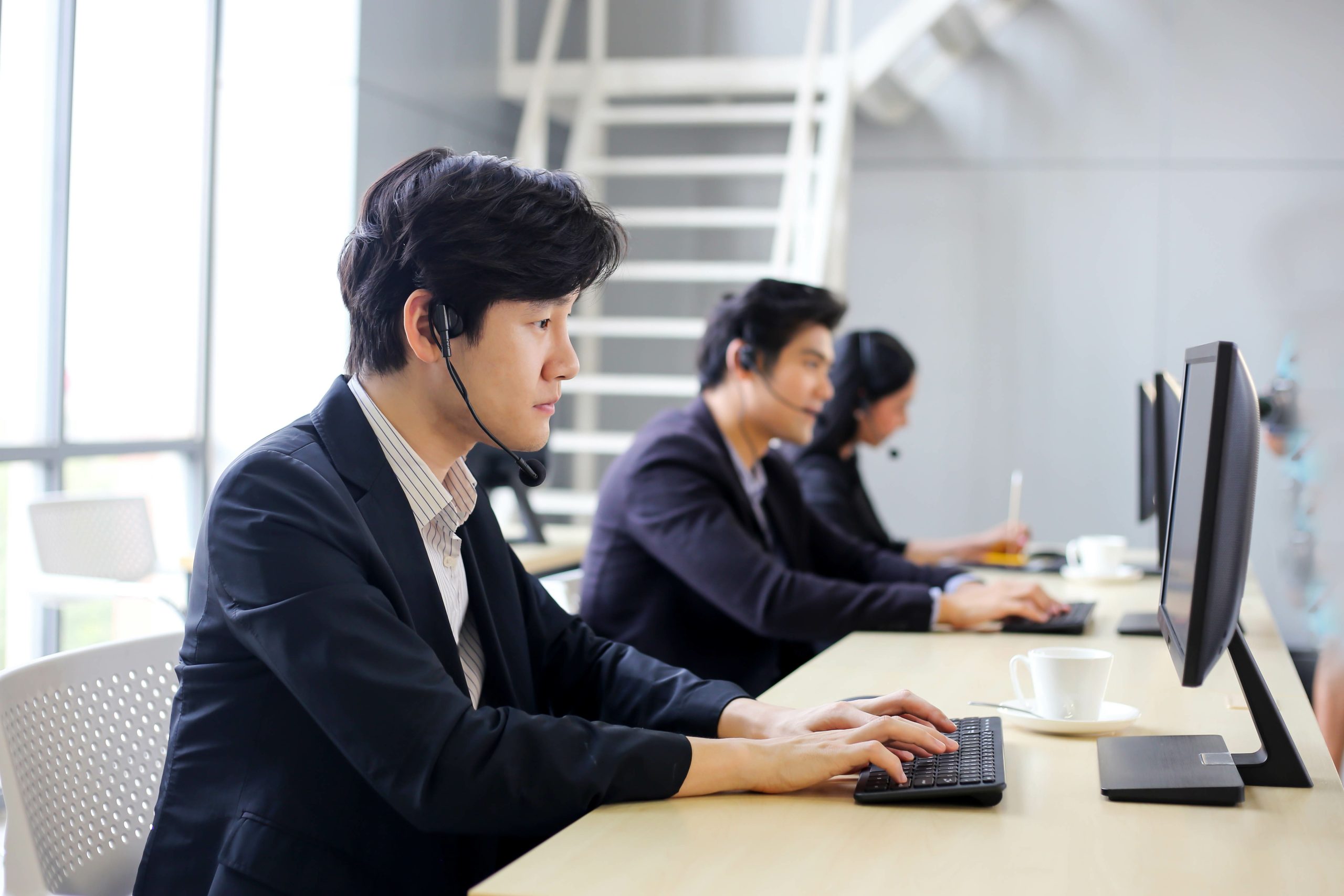 Group of condominium administrators with headset in office.