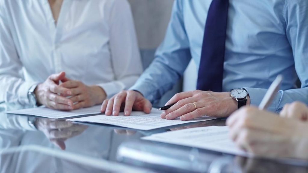 A group of condominium board members in Ontario reviewing their current management agreement in order to proceed with switching condominium property management companies.