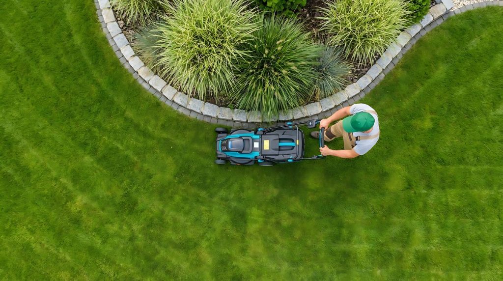 A superintendent completing maintenance work on a condominium grounds to improve landscaping.