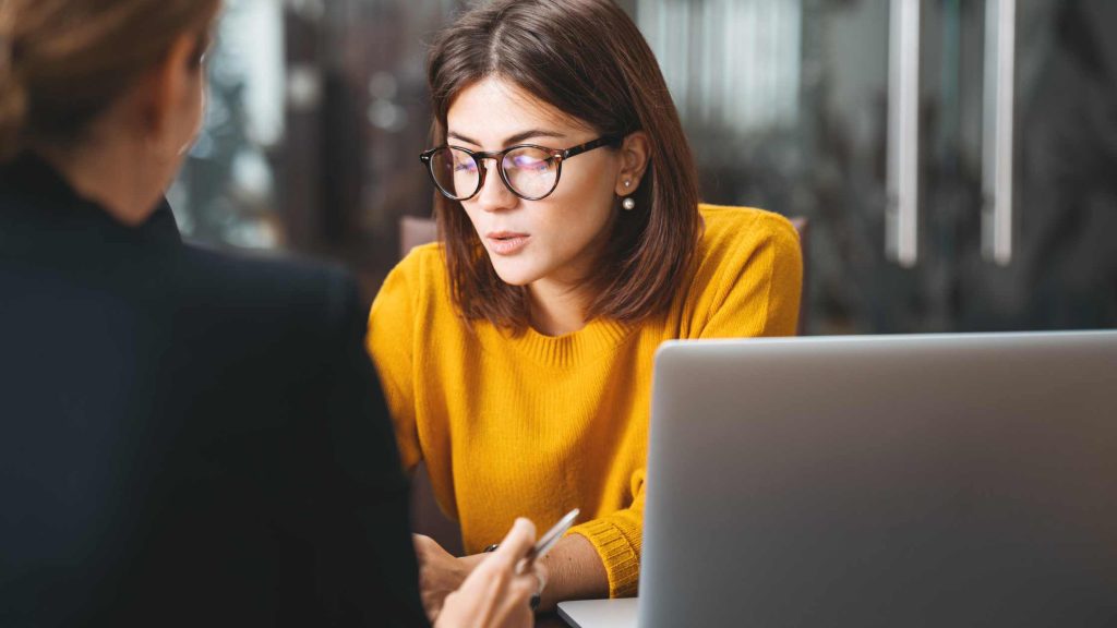 Lawyer reviewing a condo status certificate with a first-time home buyer in Ontario.