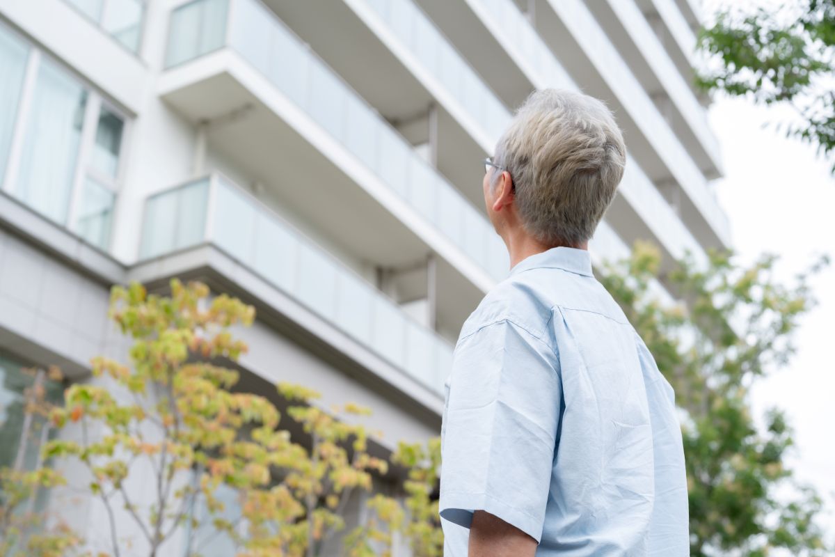 A condo board member in Ontario, Canada looking up at a condominium complex.