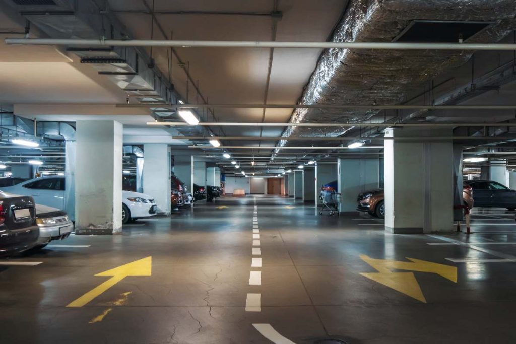 underground condominium parking garage in autumn being assessed for winter maintenance.